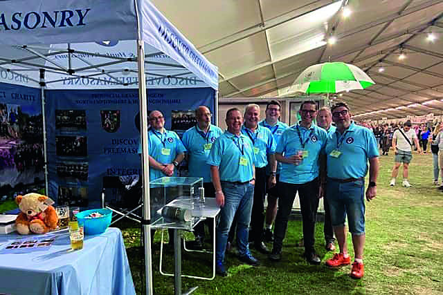 Freemasons standing by a booth