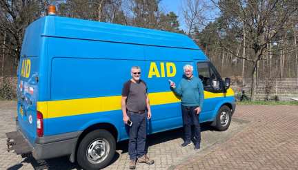 Harry Barnes, and Trevor Barrett with a large blue van. 