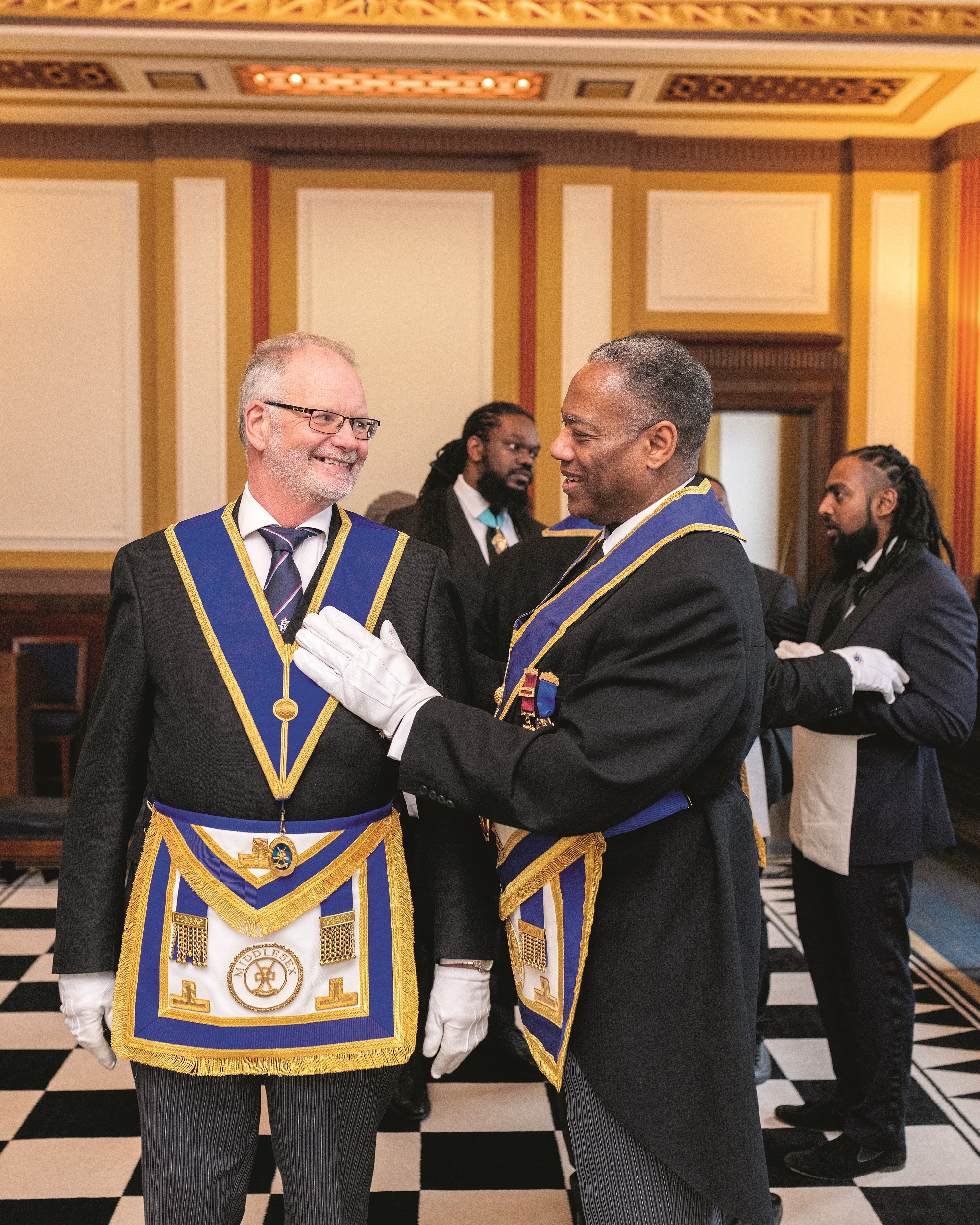 Freemasons smiling with each other in a Lodge room