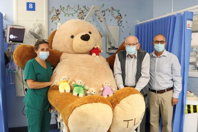 Sophie Barber, Jim Whitehead and Tony Barrios in a hospital with teddies from the charity Teddies for Loving Care