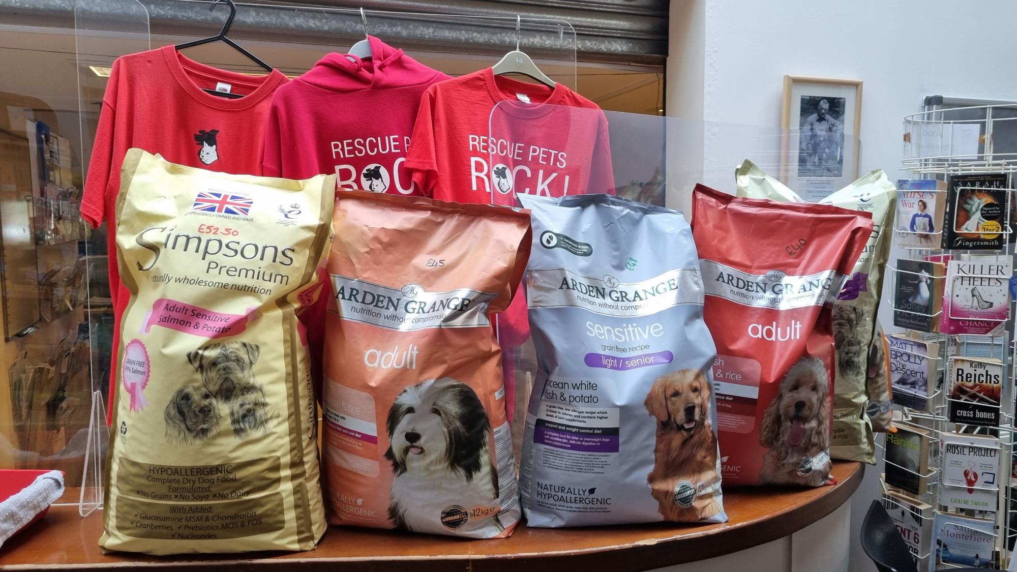 5 large bags of dog food sat on a counter