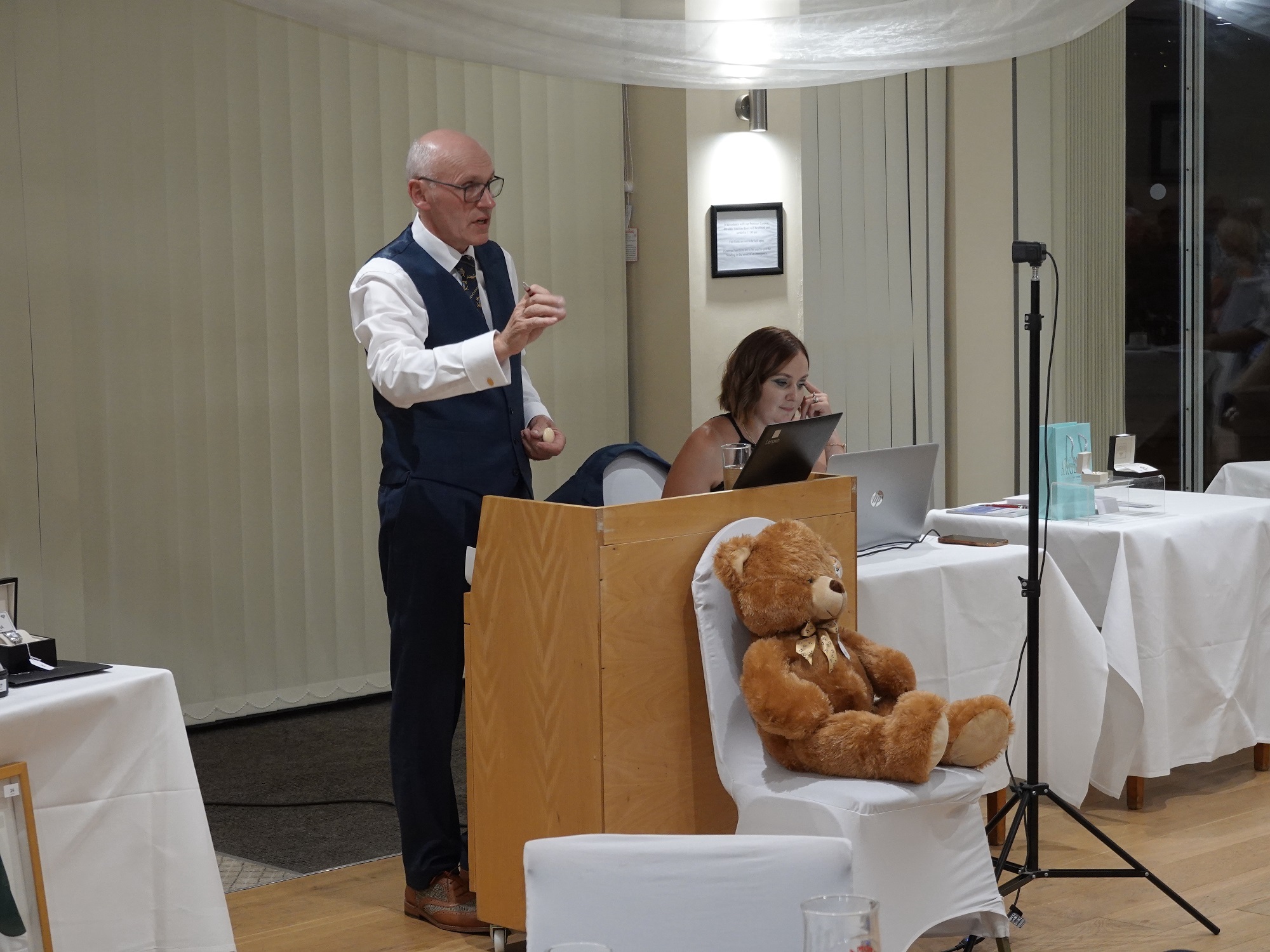 Anthony Eldred and his assistant receiving bids from across the room and online.
