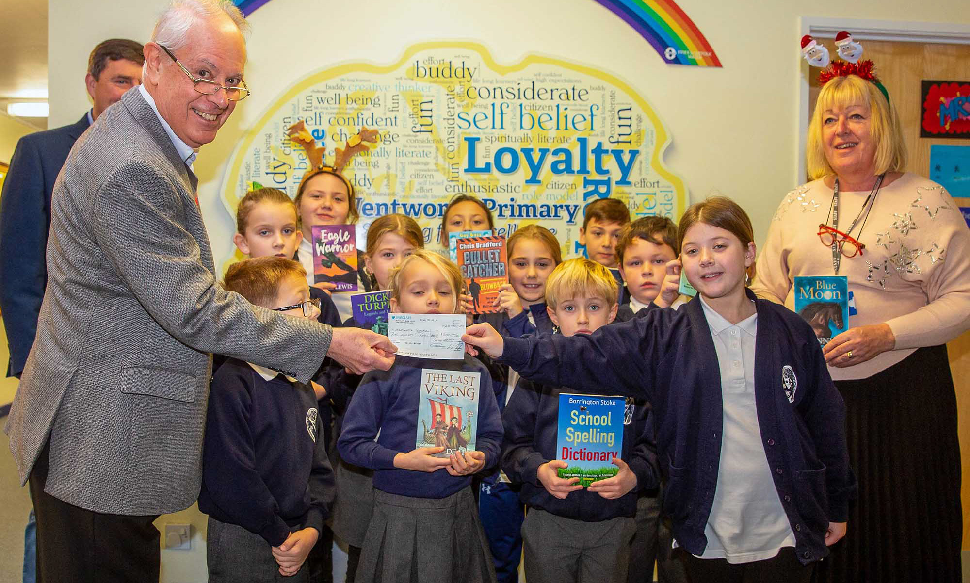 Pupils and staff at Wentworth Primary receiving a cheque for £500 from Royal Arch Mason, Martin Cook