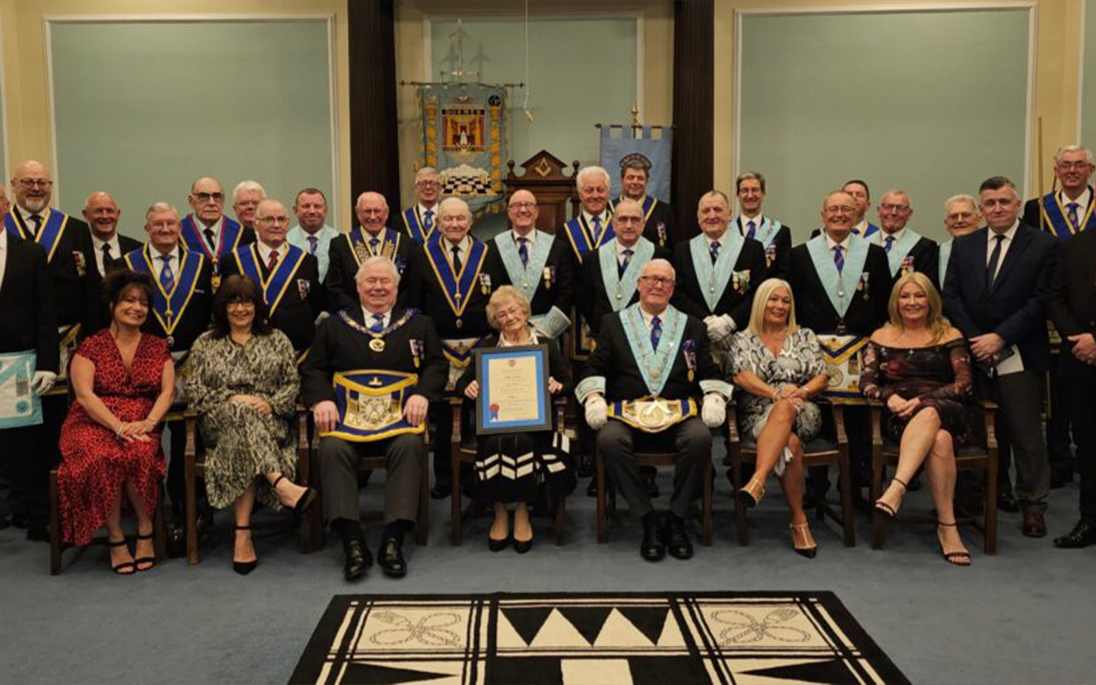 The Lodge and Alans family collecting the certificate.
