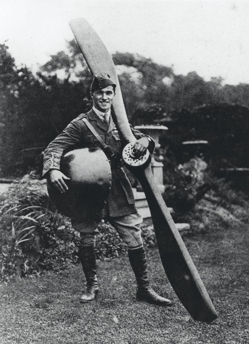 Captain Ball holding the nose and propeller from his plane, c.1917