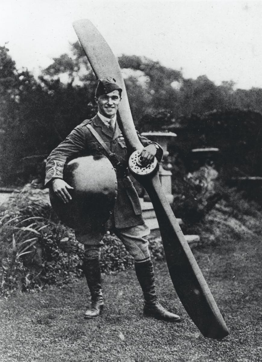 Captain Ball holding the nose and propeller from his plane, c.1917