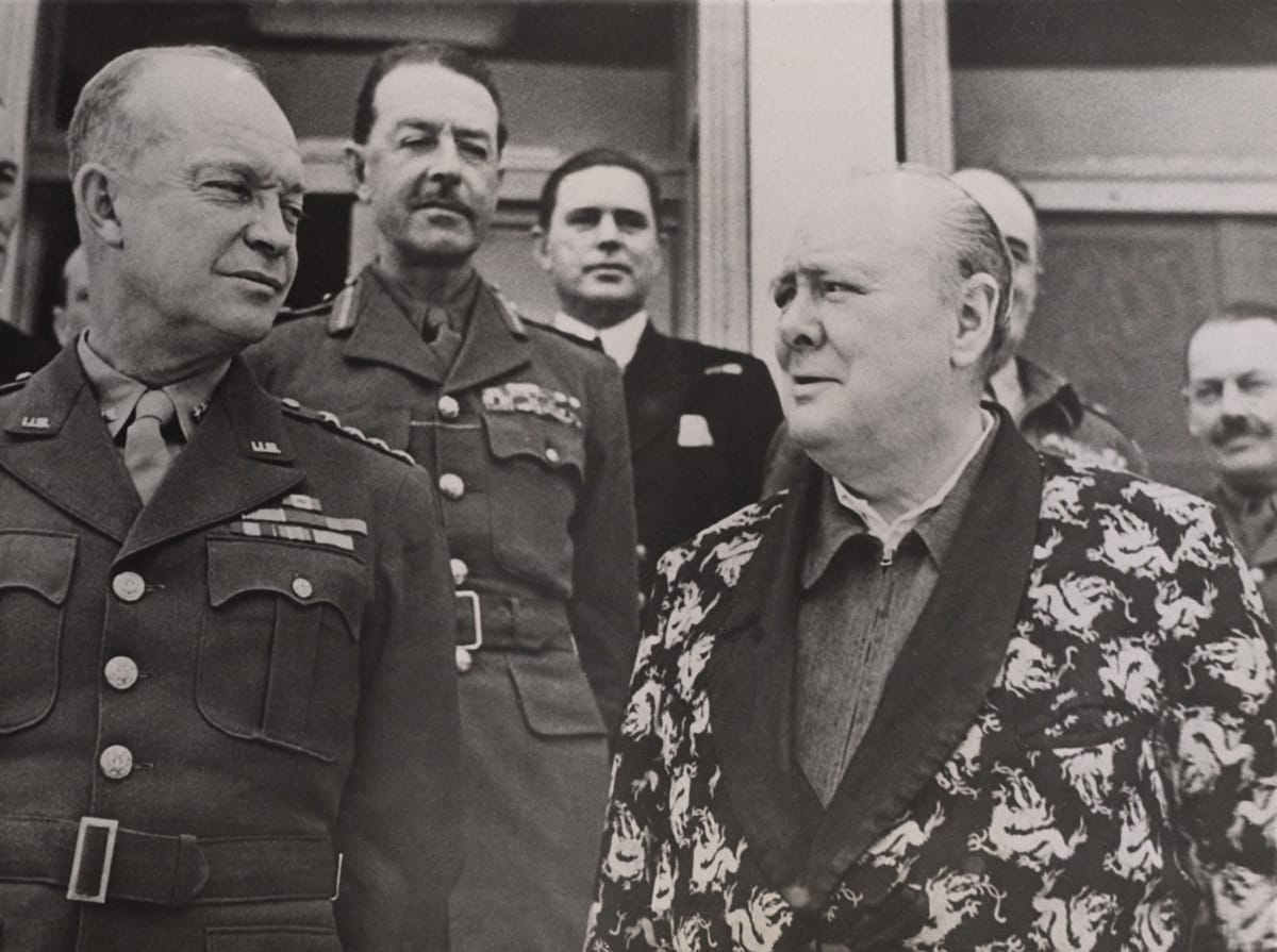 Churchill wearing his famous siren suit with General Dwight D. Eisenhower and General Sir Harold Alexander on Christmas Day 1943
