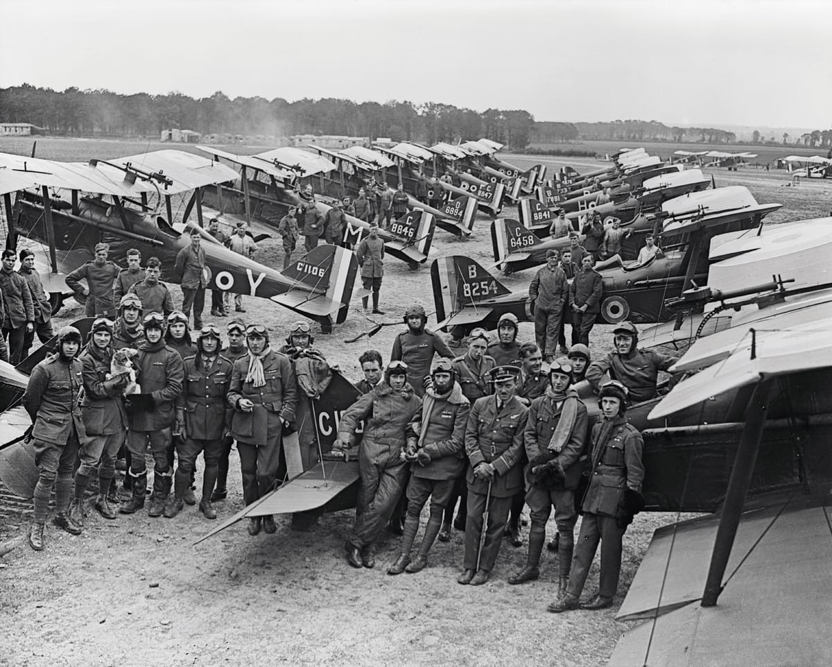 British Officers and SE 5a Scouts of No. 1 Squadron. The group includes two Americans, Lieutenants D. Knight and H.A. Kuhlberg, July 1918