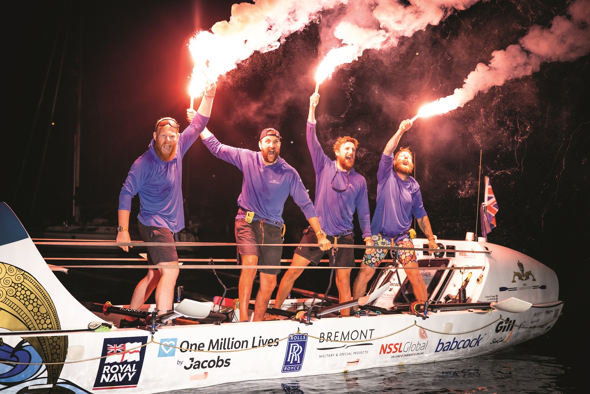 Photo of four men in a boat with fireworks in hand 