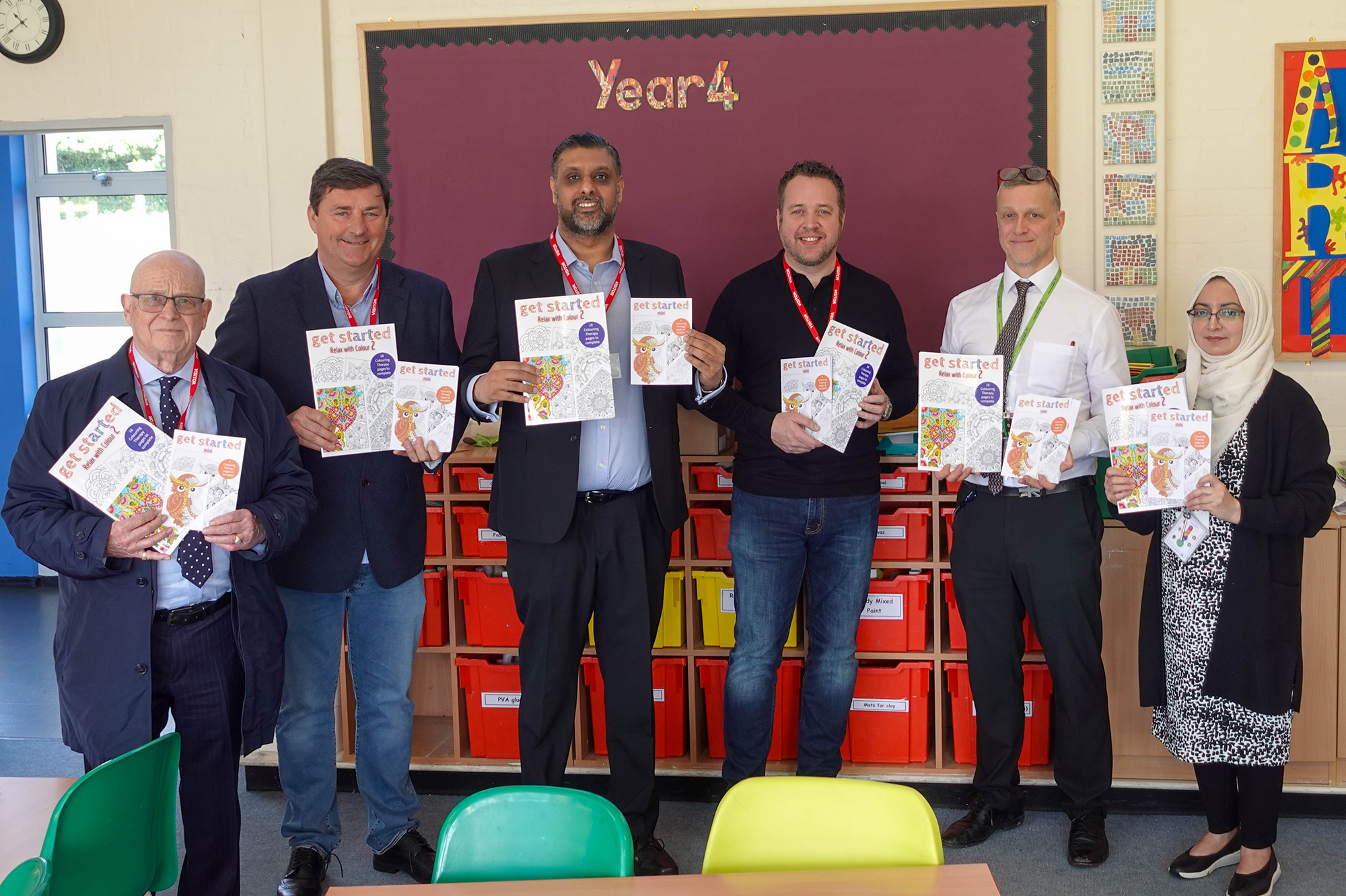 Essex Freemasons with school children displaying their competition entries 