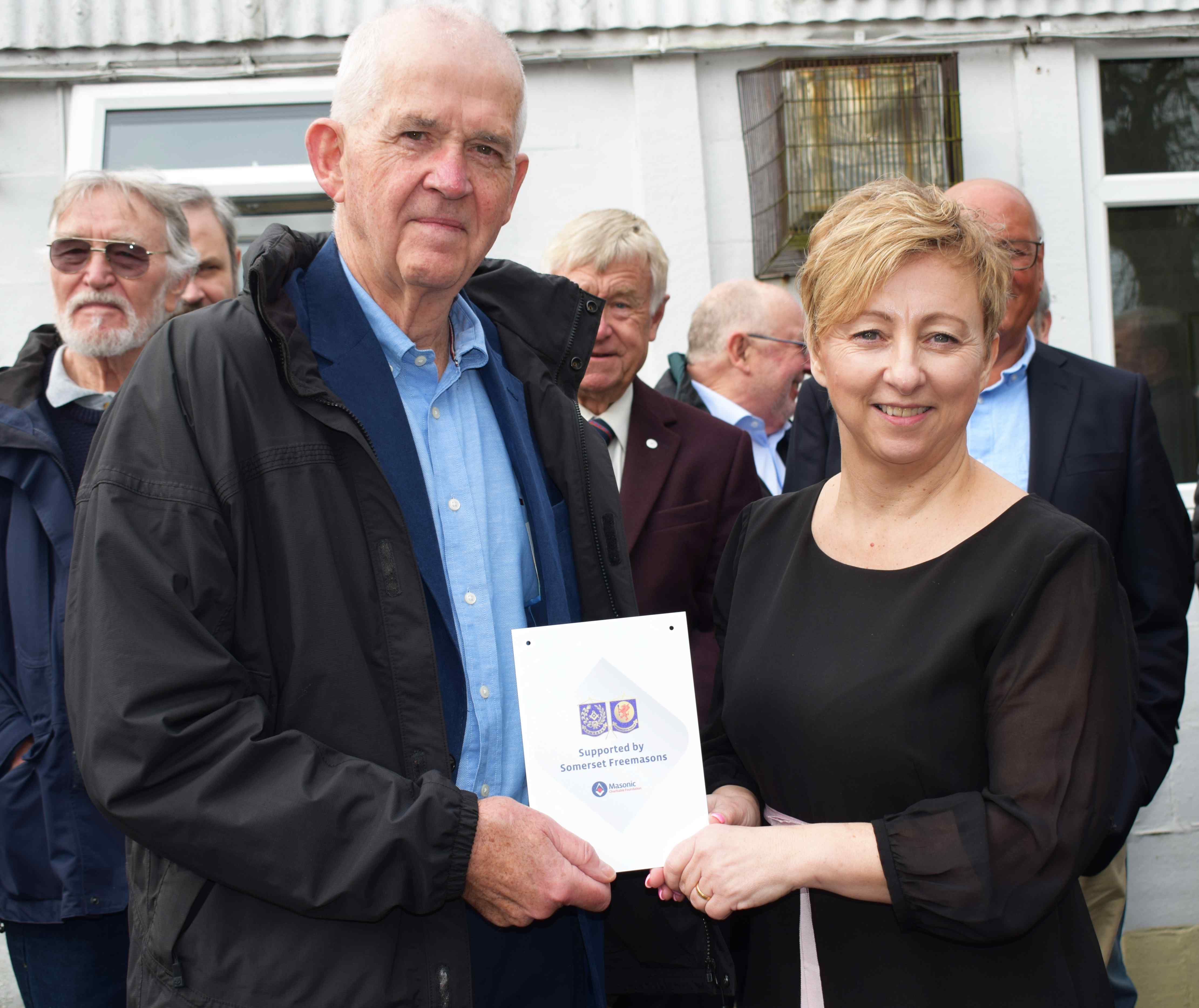 Ray Guthrie, Head of Somerset Freemasons, presenting a cheque to SWALLOW