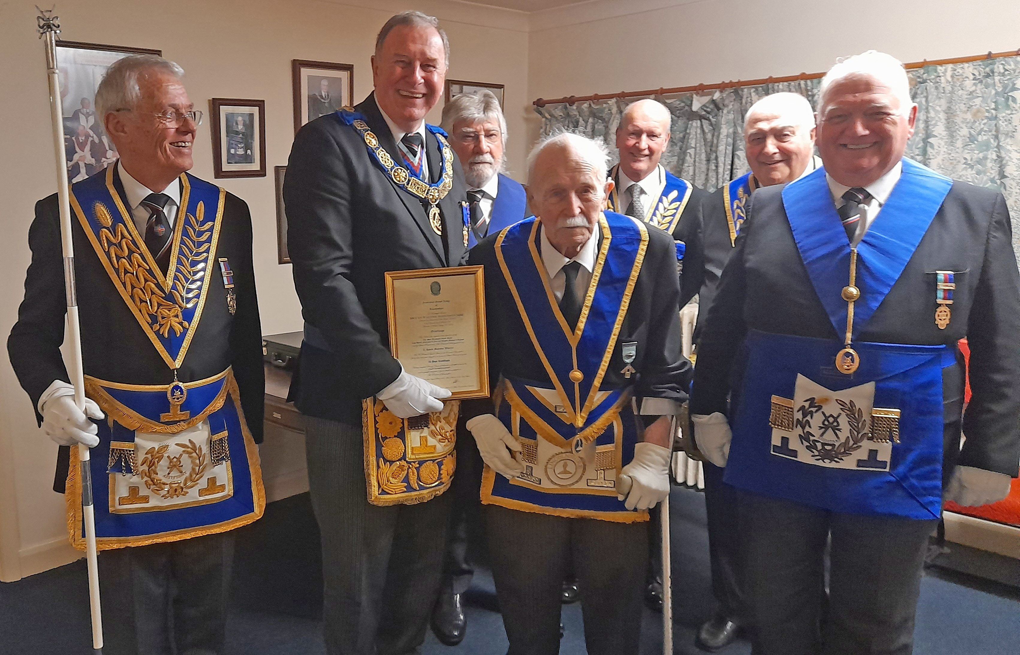 Bryan Robinson receiving a certificate commemorating his 70 years of membership as a Freemason 