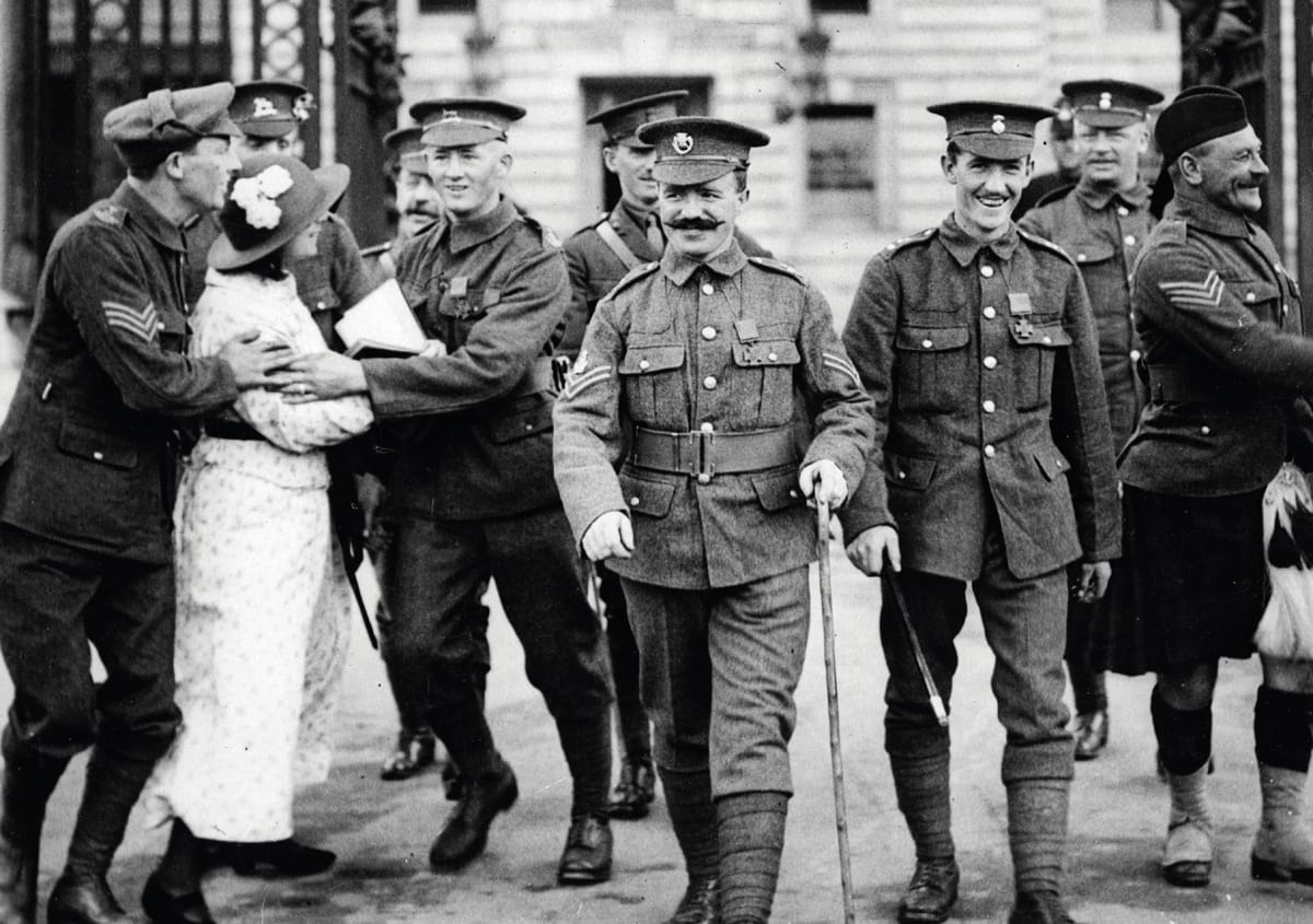 An autograph hunter held back as she attempts to reach group of soldiers leaving Buckingham Palace following investiture ceremony, c.1918