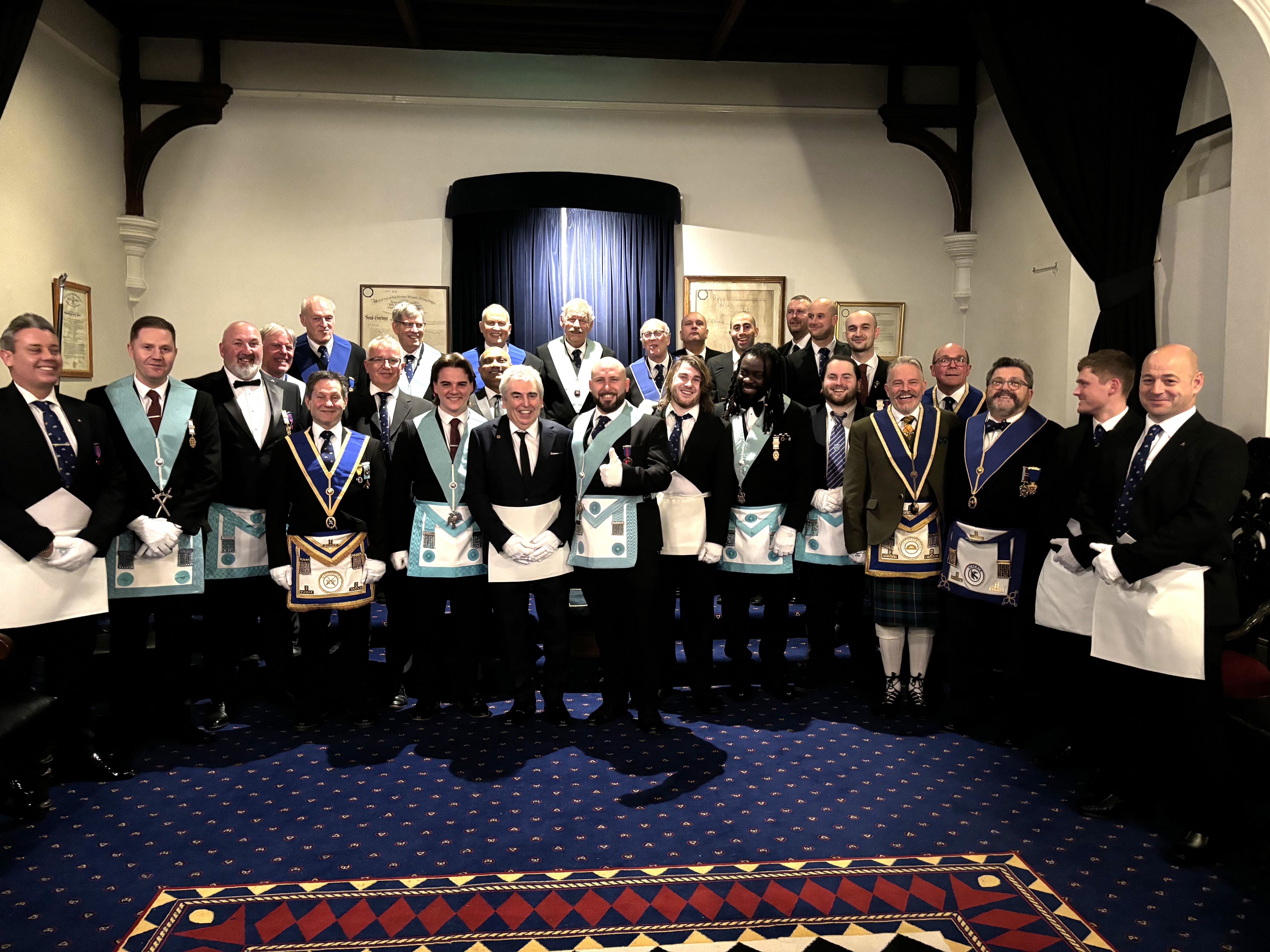 Freemasons of Sarum Lodge in Wiltshire talking a group photo in their Lodge Room after the Initiation of Bro Richard