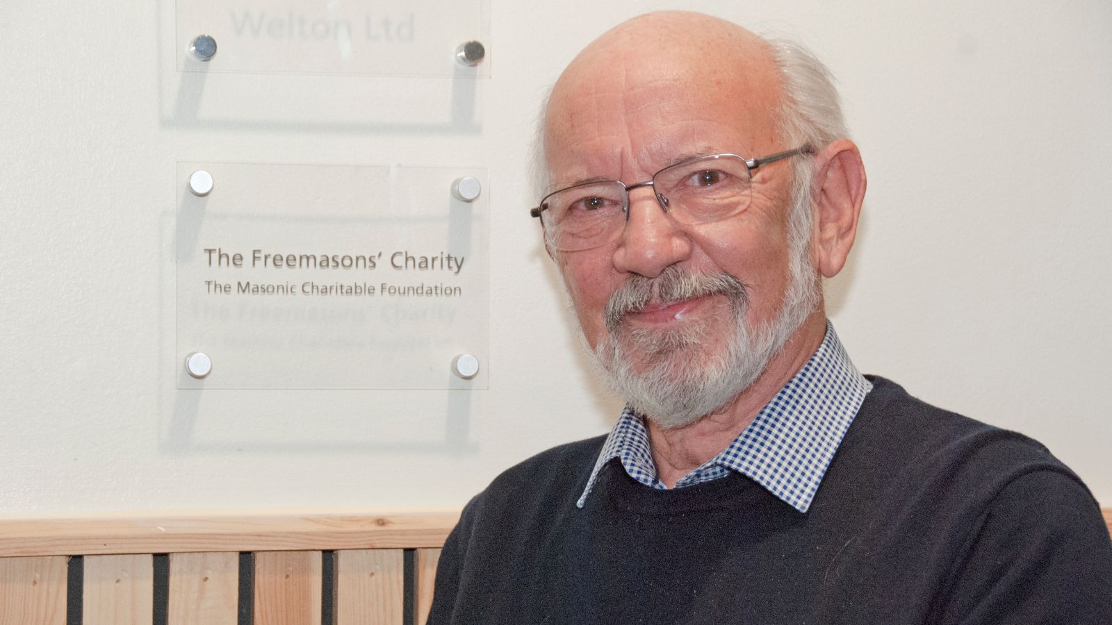 Pete Tong, Lincolnshire’s Charity Steward, infront of a sign for the Masonic Charitable Foundation