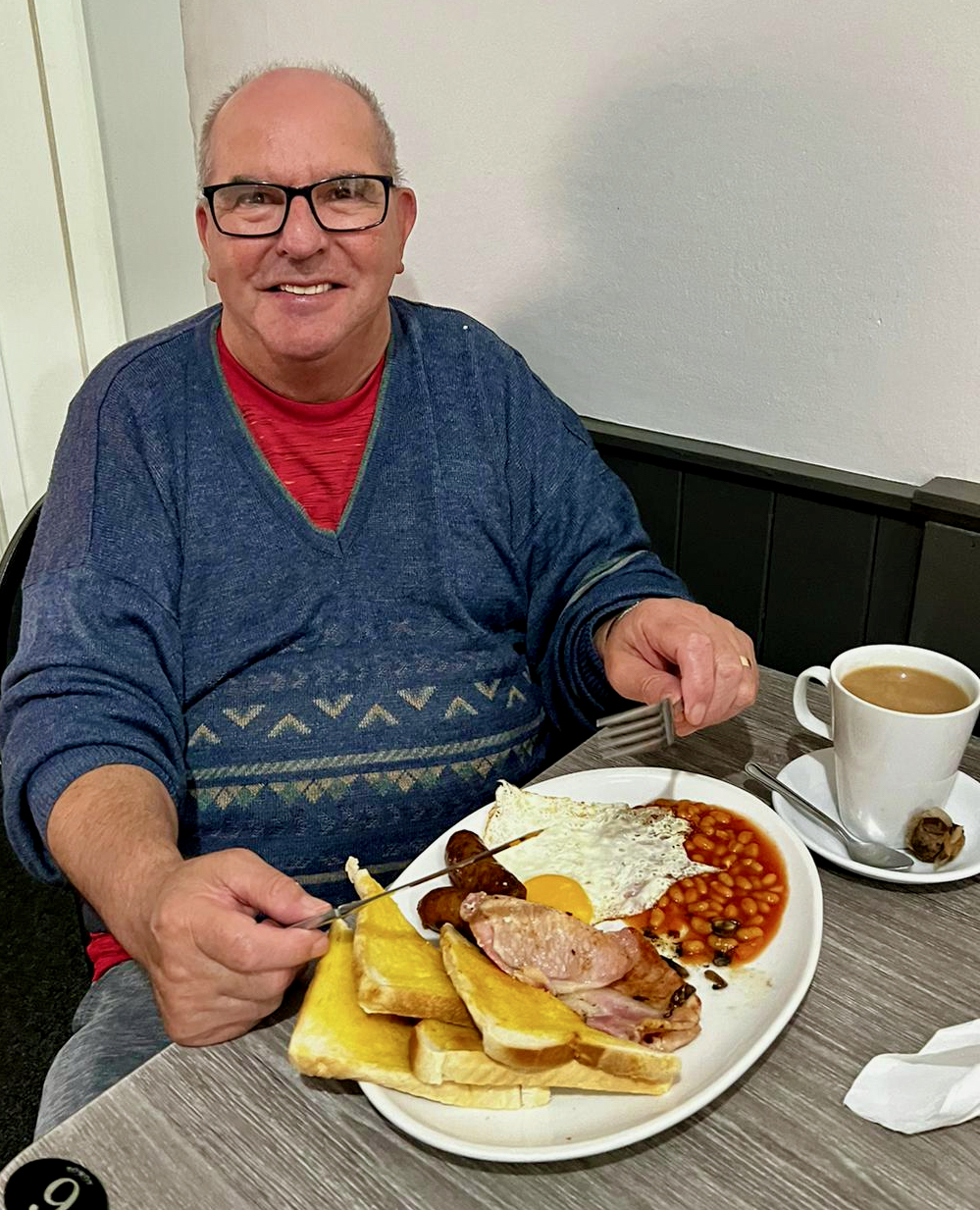 male carer eating breakfast with the support group