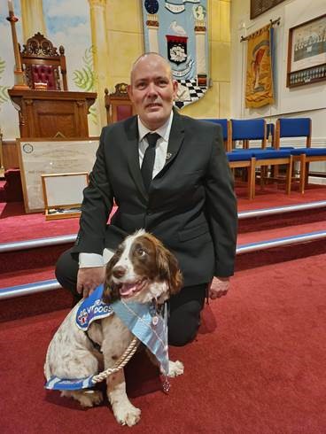 Freemason Nick Thomas from Prudence Lodge assisted by Busby, dog from Veterans With Dogs