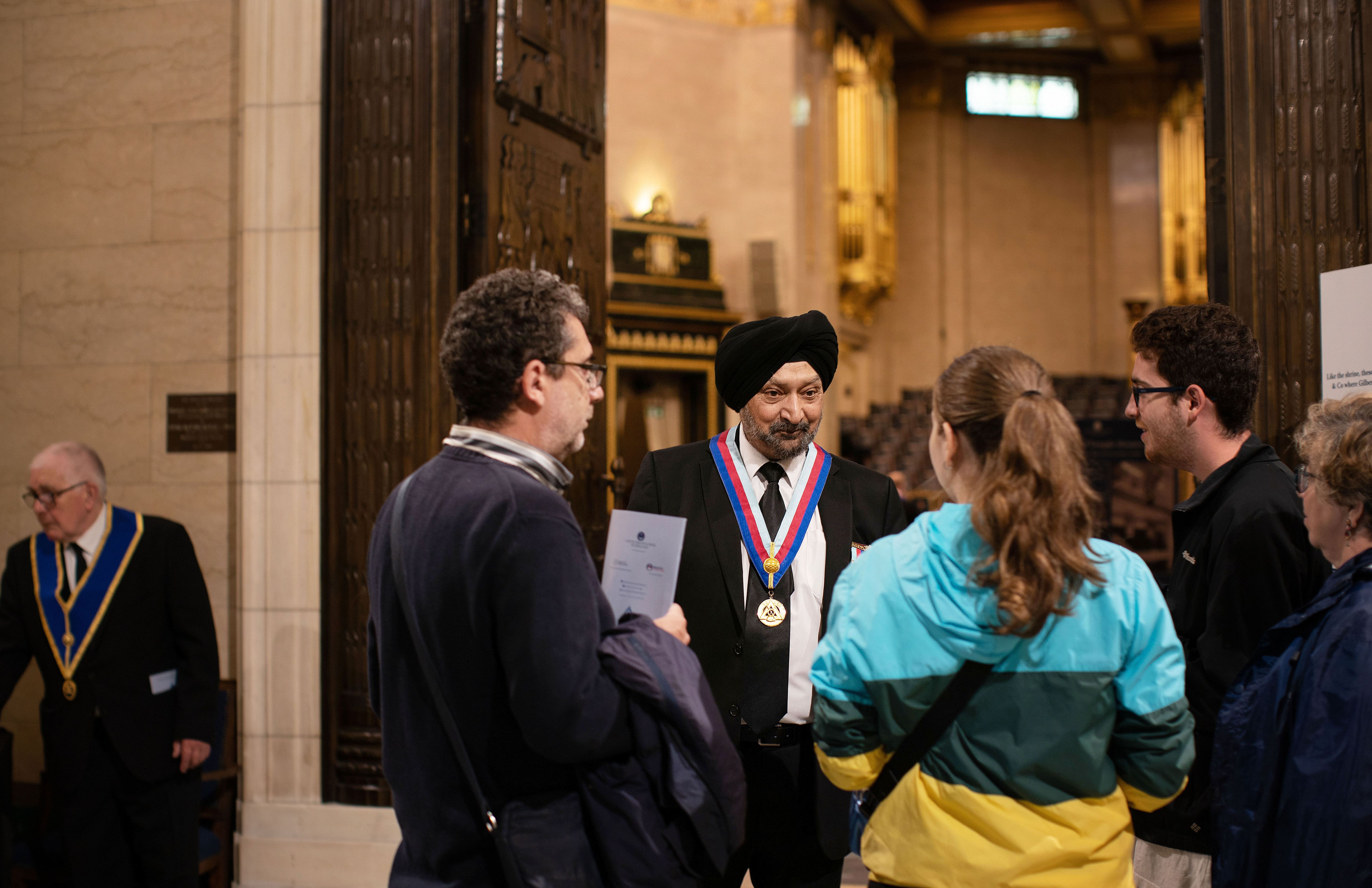 Visitors talking to a Freemason at Freemasons Hall