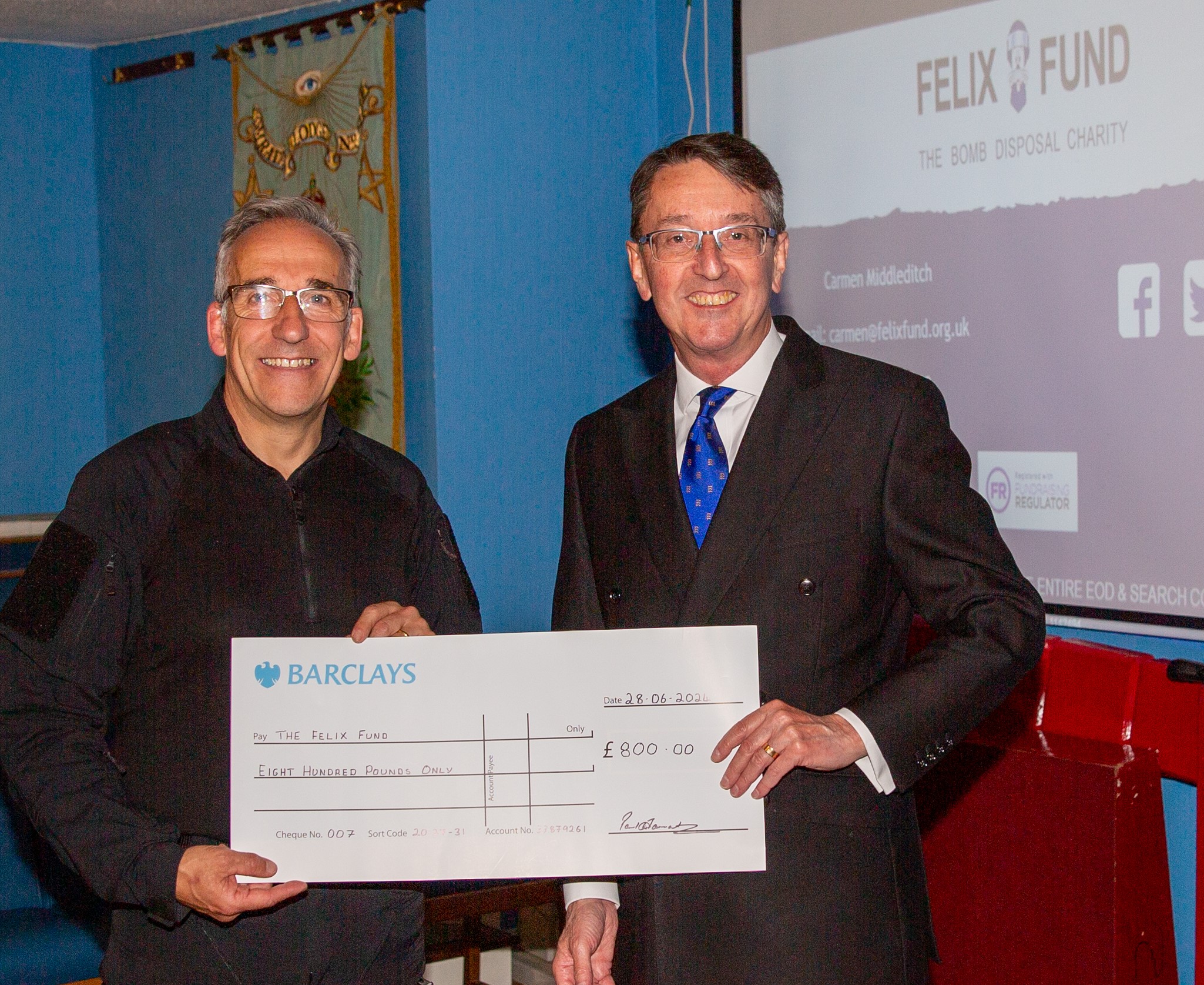 Essex Freemason presenting £1600 cheque to Felix Fund Bomb disposal charity