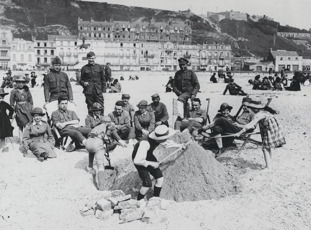 British, American & French troops relaxing on a beach with French children and members of the Women’s Army Auxiliary Corps (WAAC), c.1917