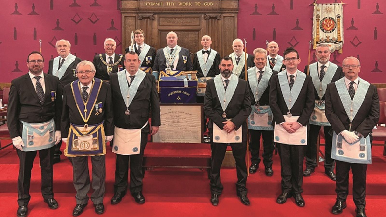 Freemasons in a Masonic Lodge, wearing aprons and collars to signify their varying ranks within the organisation.