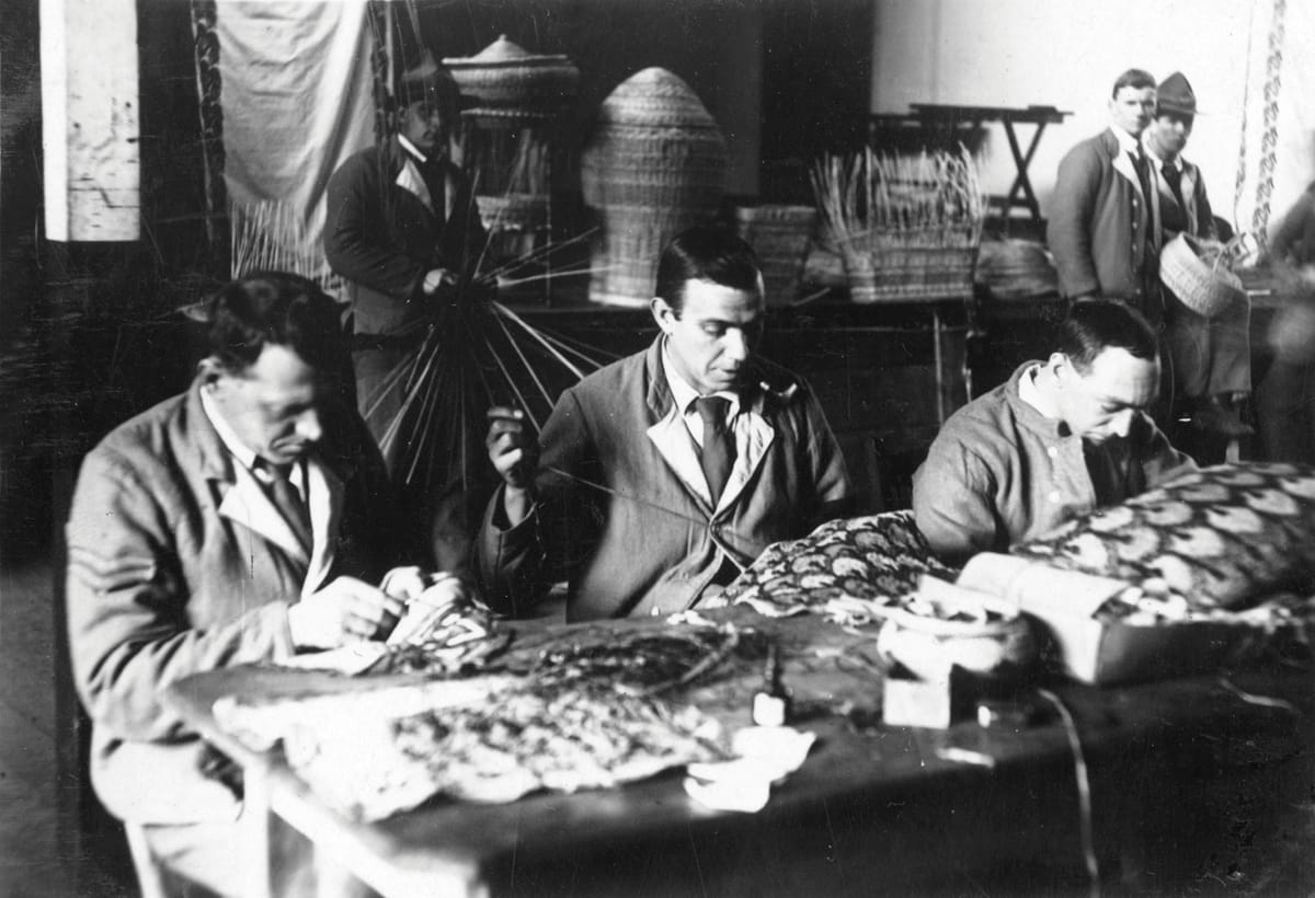 Putting liners into sewing baskets in the workshops of the Fulham Road branch of the Lord Roberts Memorial Workshops, c.1918