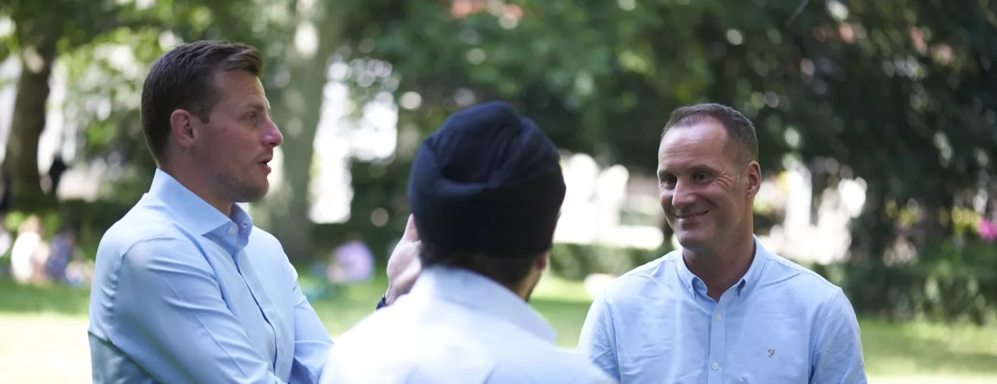 Three Freemasons from the Universities Scheme are having a chat at the park