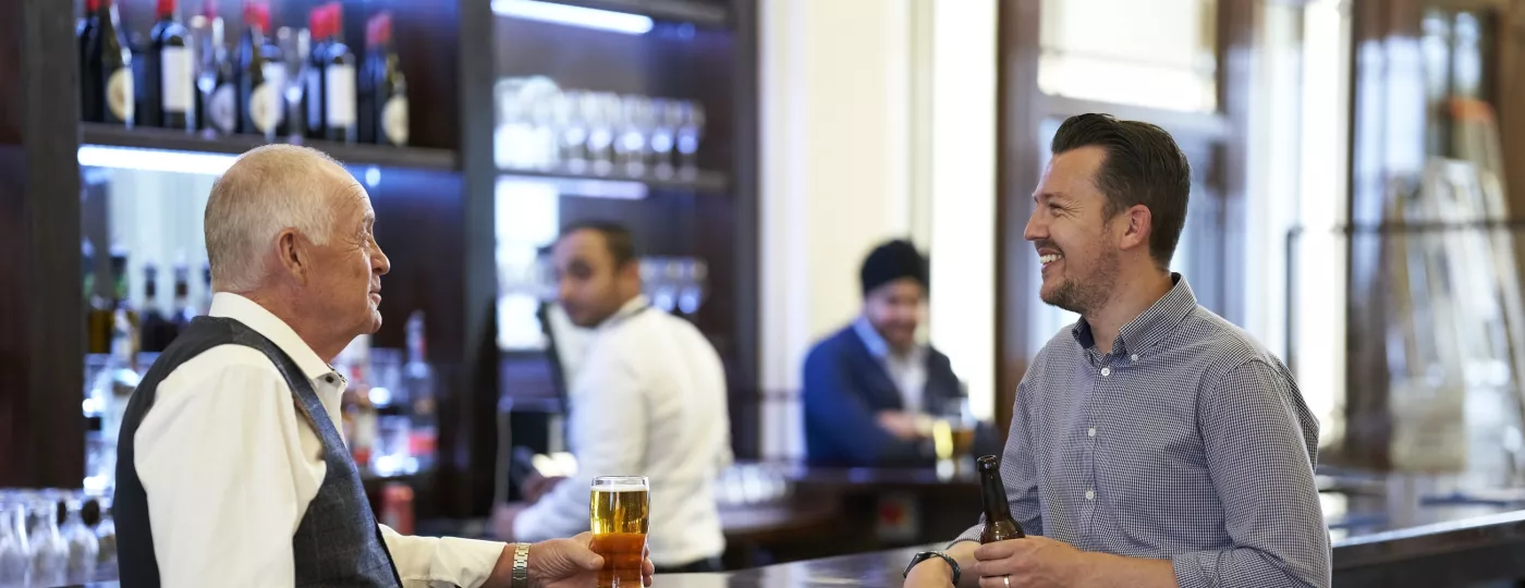 Two Freemasons are enjoying a beer at the Café and Bar at Freemasons Hall in London
