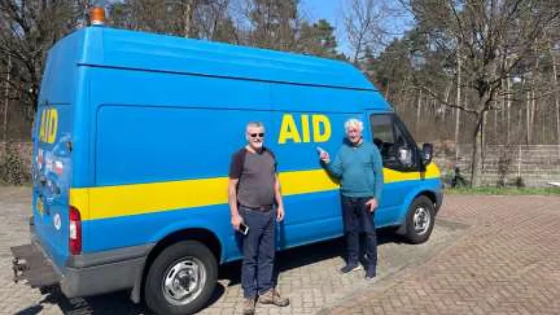 Harry Barnes, and Trevor Barrett with a large blue van. 