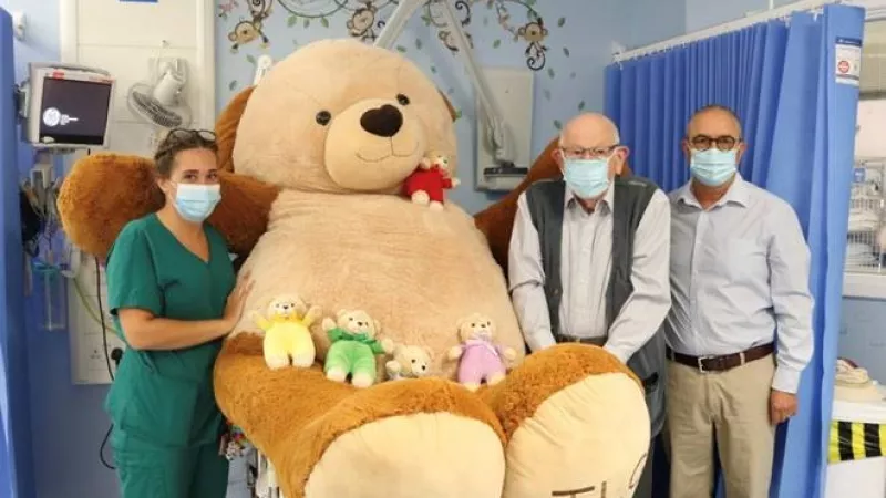 Sophie Barber, Jim Whitehead and Tony Barrios in a hospital with teddies from the charity Teddies for Loving Care