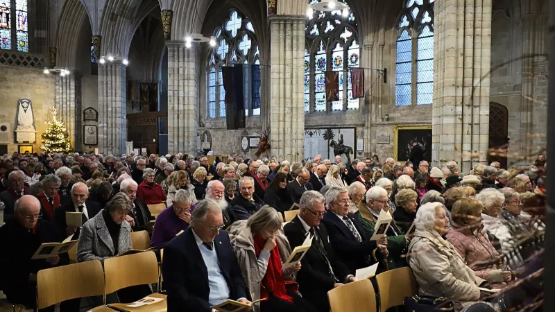 The inside or a cathedral packed with people.