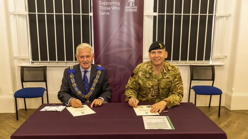 Head of Freemasonry for the Province of East Kent, Neil Hamilton Johnstone, wearing full regalia, and Lieutenant Colonel David Hirst signing the covenant