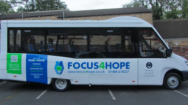 Focus4Hope's new 16-seat minibus, which with blue and green decals.