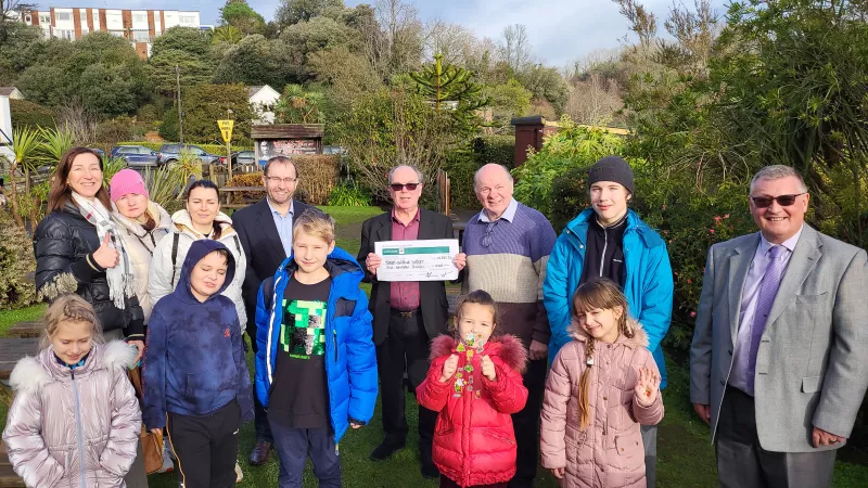 Dr David Harwood and Simon Chapman were joined for the presentation by some of those they are supporting - Svitlana, Nataliia, Lana, Sophia, Tim, Gleb, Mariia, Karina and Denys, the children enjoying a day out in the Torquay winter sunshine.