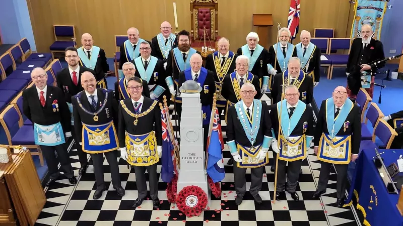 Members of both lodges in full regalia stood either side of the Cenotaph replica