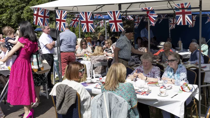 People at a cream tea for widows at a remembrance garden