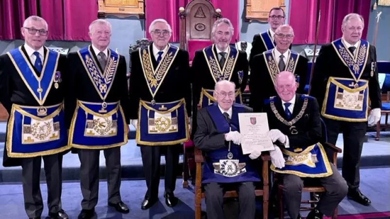 John H. Farrall and the rest of the lodge with his long service certificate in full regalia.