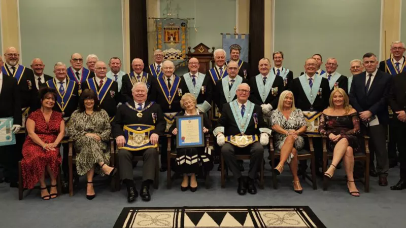 The Lodge and Alans family collecting the certificate.