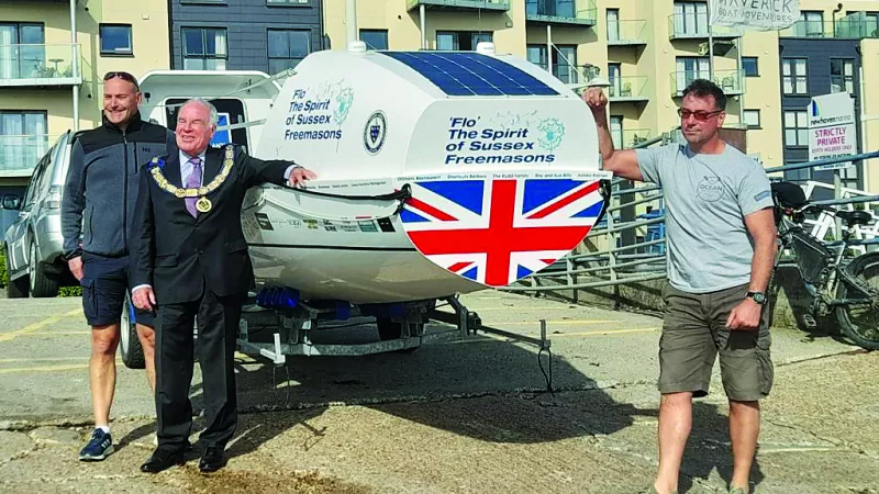 Matt Garman, Neil Furminger and Steve Woolley with the boat the sailed 3000 miles in