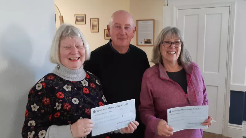 Dorset Freemasons presenting cheques