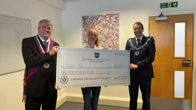 Freemasons in Cheshire handing over a check to Elsies Moon 