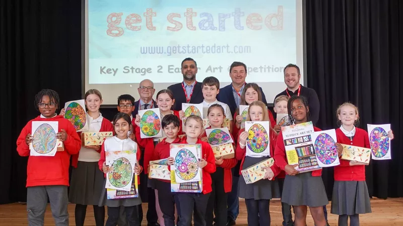 Essex Freemasons with school children displaying their competition entries 