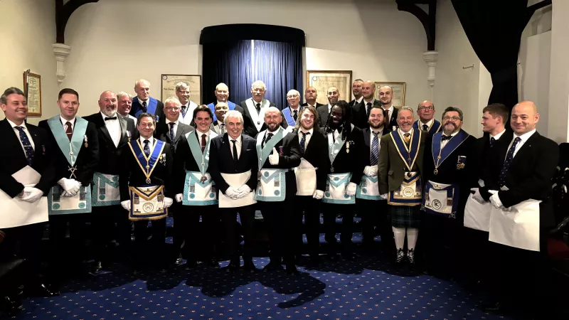 Freemasons of Sarum Lodge in Wiltshire talking a group photo in their Lodge Room after the Initiation of Bro Richard