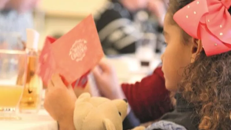 A little girl receives a Christmas card