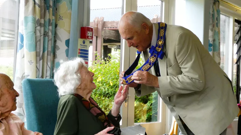 The photo shows the Provincial Grand Master of Dorset Freemasons,, Stephen James explaining his chain of office at a Dorset Blind Association presentation afternoon in Weymouth.