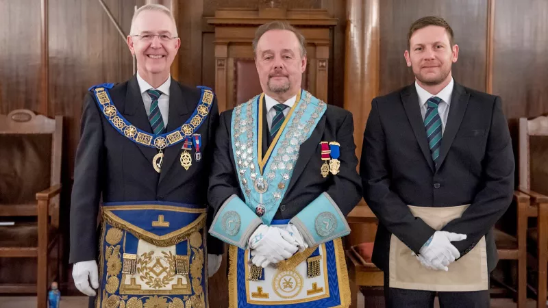 Provincial Grand Master of Worcestershire stands with other two Freemasons during a four ceremonies in a day event