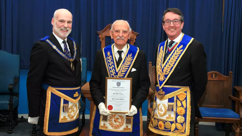 Rob Eels, Peter Bidmead, Paul Tarrant, stand in a row wearing full regalia