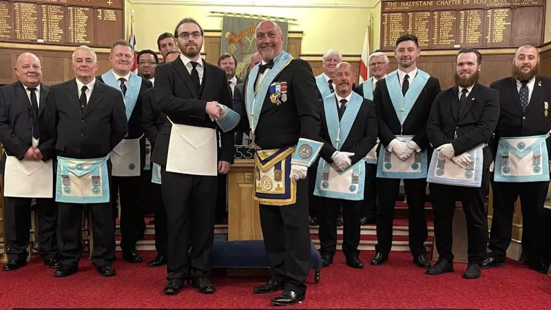 Lewis being initiated into his fathers lodge.