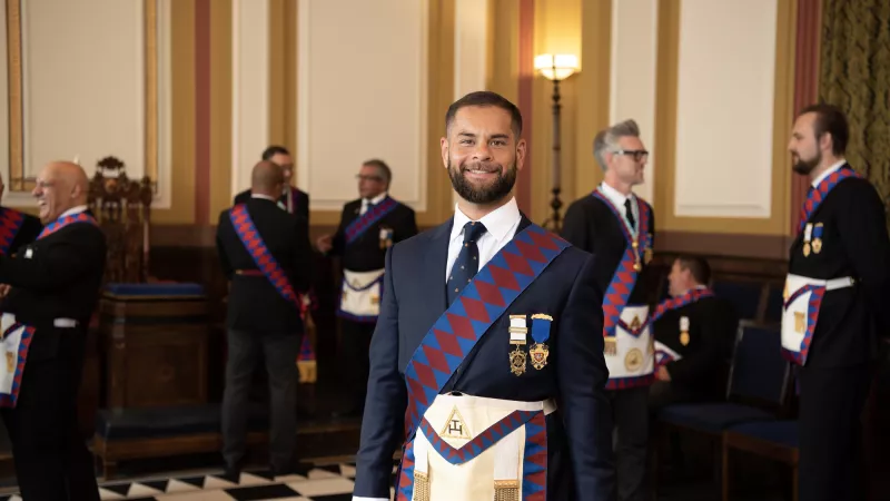 A Freemason wearing a regalia inside the Lodge