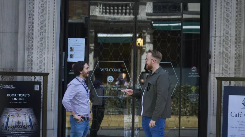 Employees of United Grand Lodge of England talking in front of Freemasons Hall in London